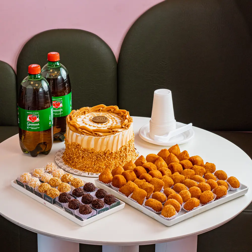 Kit com bolo caramelo, brigadeiros, coxinhas, dois guaranás e copos